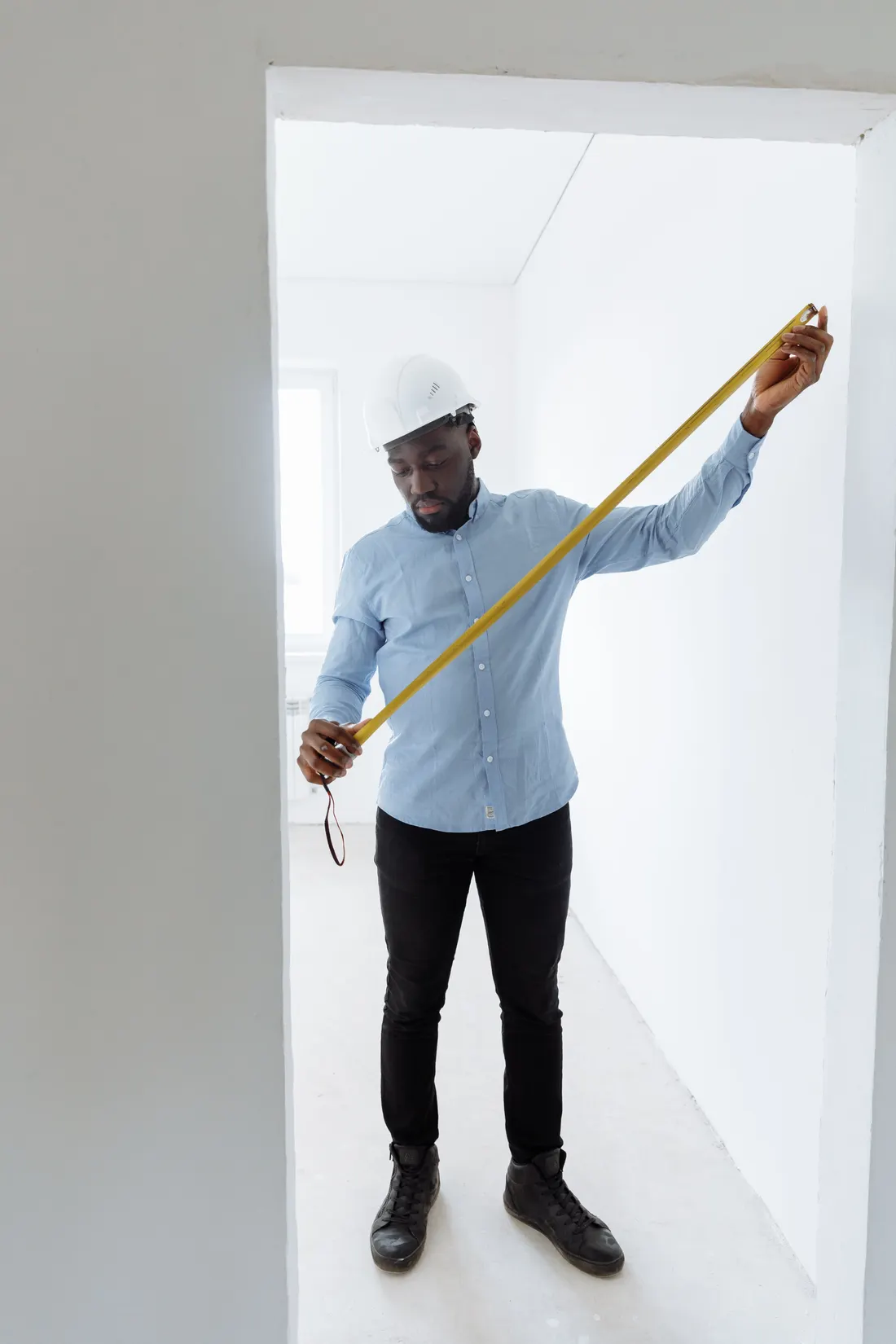 Contractors measuring a room before a home project